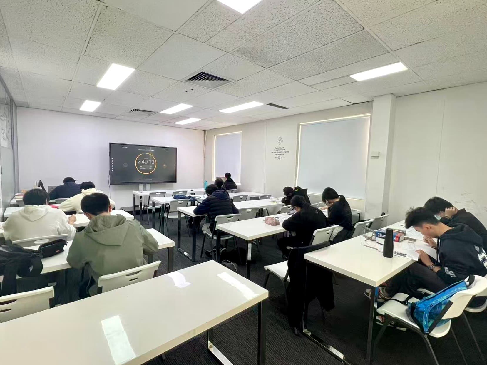 Austin Education students sitting a timed VCE mock exam with a countdown clock displayed at the front of the room