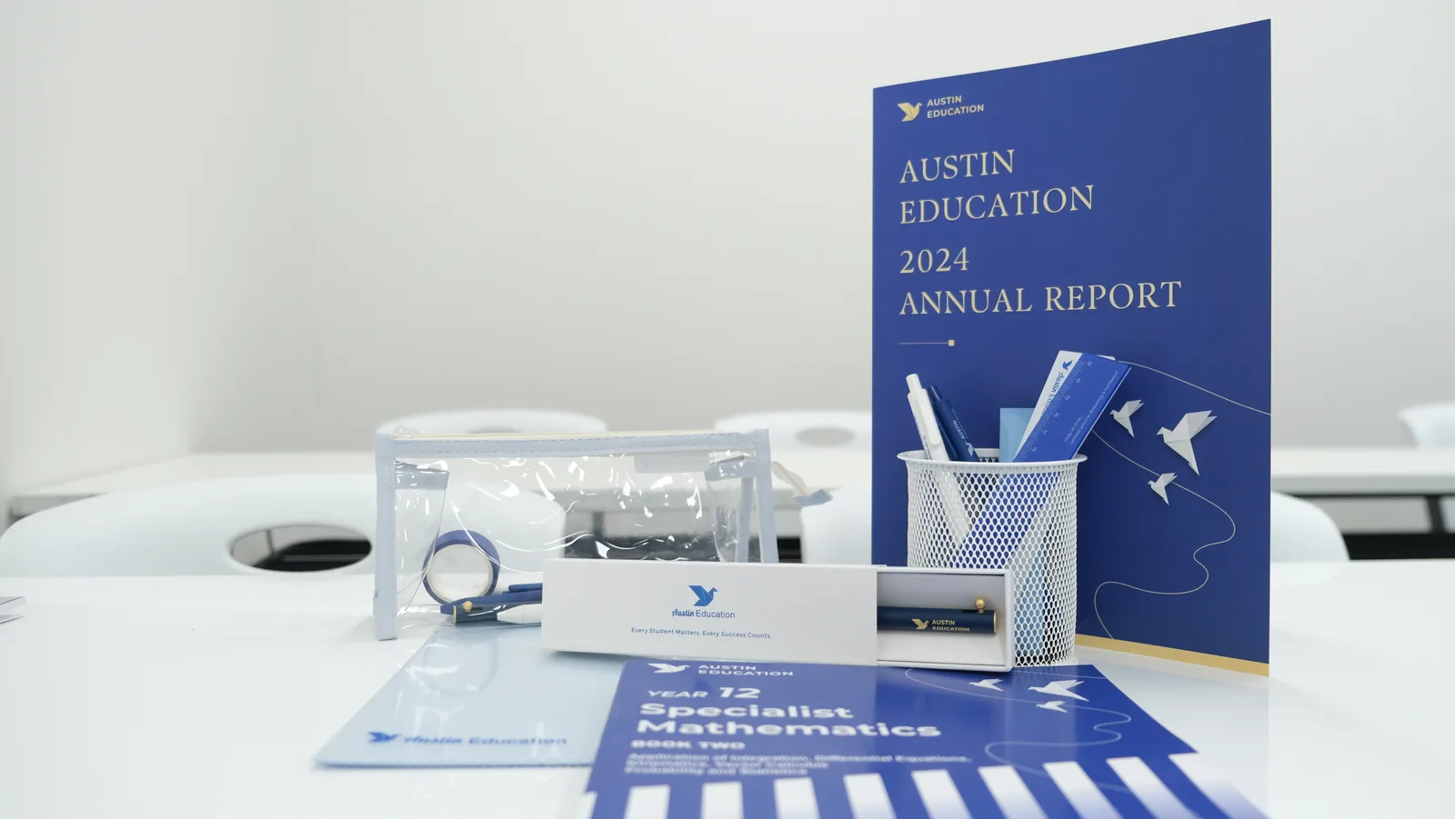 Austin Education VCE Specialist Mathematics textbook and annual report on a classroom desk